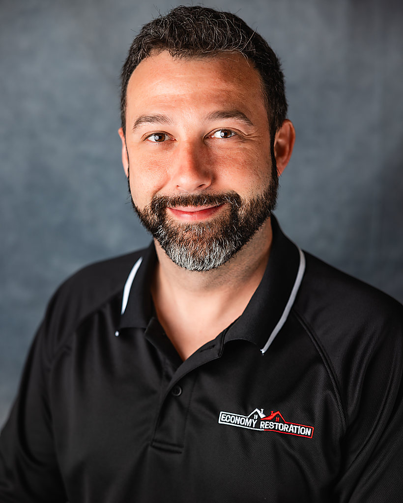 A business headshot on a gray backdrop